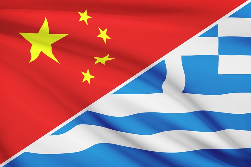 Flags of China and Greece blowing in the wind.