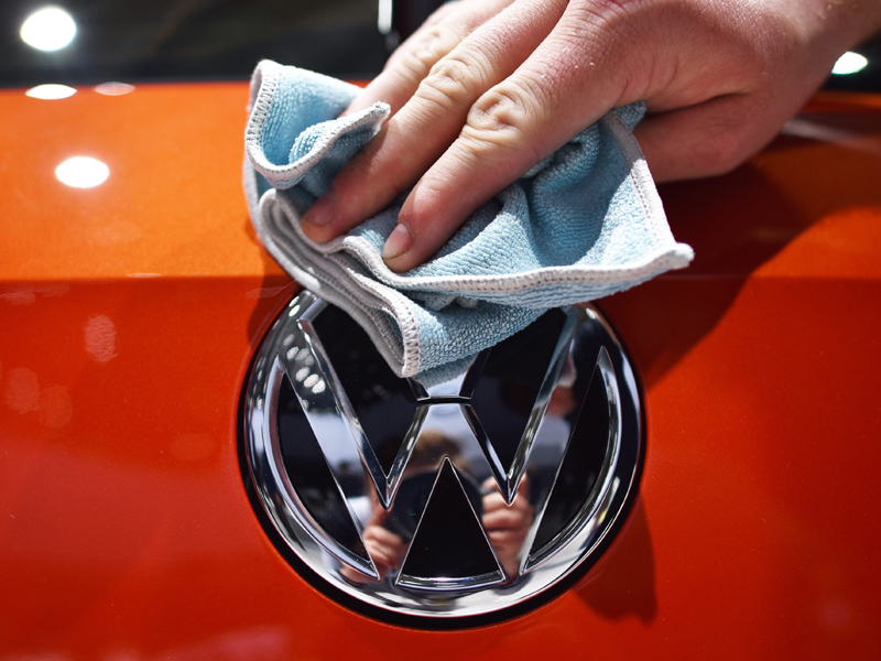 epa04863569 (FILE) A file photo dated 05 May 2015 showing an assistant polishing a VW logo at the Volkswagen AG shareholders' meeting at the fairground in Hanover, Germany. Germany's Volkswagen has taken the crown as the world's top carmaker after its sales overtook those of Japanese rival Toyota during the first half of the year, it was reported 28 July 2015. Toyota, the manufacturer of Prius hybrid, Camry sedan and the top-of-the range Lexus, said its group sold 5.02 million vehicles worldwide in the six months ended June, down 1.5 per cent from a year earlier due to weak domestic sales. Volkswagen, which has a long-held goal to overtake Toyota as the world's number, said this month it sold 5.04 million vehicles in the six-month period. VW sales also fell during the first six months of this year, sliding by 0.5 per cent after strong demand in North America and Europe failed to offset a drop in sales in China - the world's biggest car market.  EPA/OLE SPATA